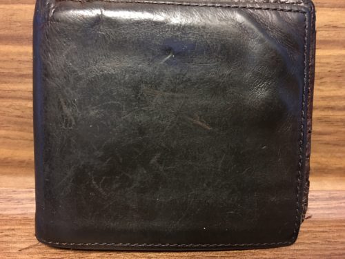 Image of one side of the outside of the wallet before the repair