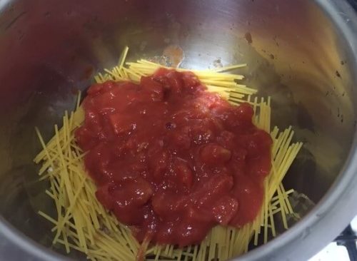 Image of pasta and canned tomato in a sandwich