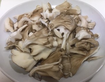 Image of torn maitake mushroom.