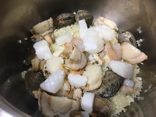 Image: Putting seafood into the pot